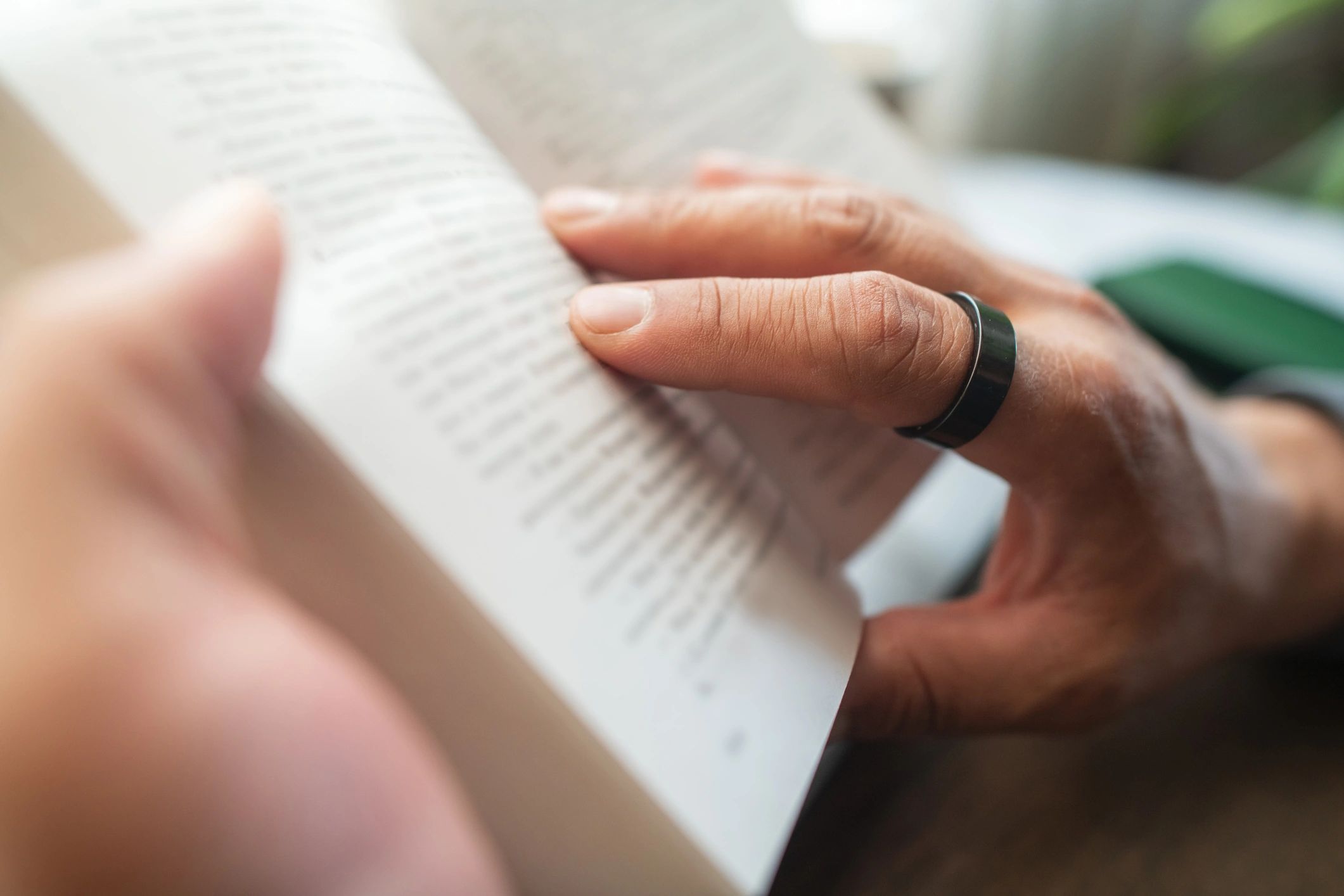 Close-up of a person reading a book indoors